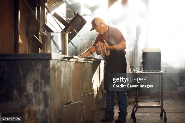 chef making sausage in kitchen - chef full length stock pictures, royalty-free photos & images