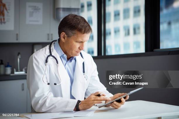 Doctor Using It Male Doctor Using Tablet Computer In Clinic High-Res Stock Photo ...