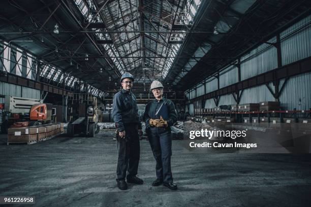 portrait of confident coworkers standing in metal industry - steel worker stock pictures, royalty-free photos & images