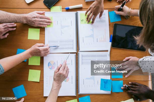 high angle cropped image of business people planning in board room - portatil en oficina subjetivo pantalla fotografías e imágenes de stock