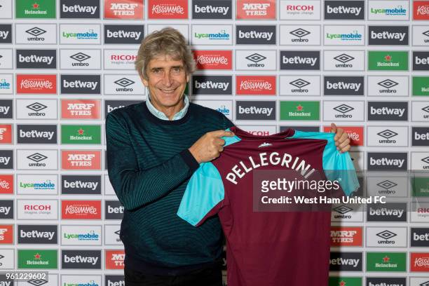 West Ham United's new manager Manuel Pellegrini poses with a shirt on May 21, 2018 in London, England.