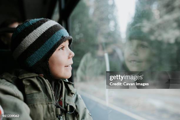 smiling boy looking through window in tour bus at yosemite national park - kid looking through window stock pictures, royalty-free photos & images