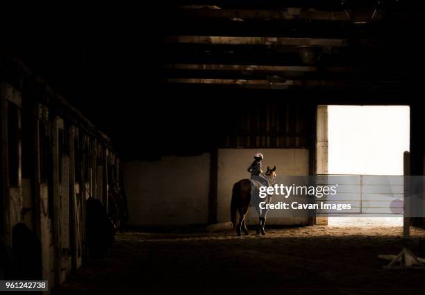 carefree girl horseback riding at stable - pferdestall stock-fotos und bilder