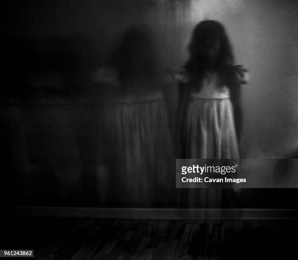 double exposure of spooky girl against wall at home - fantasma fotografías e imágenes de stock