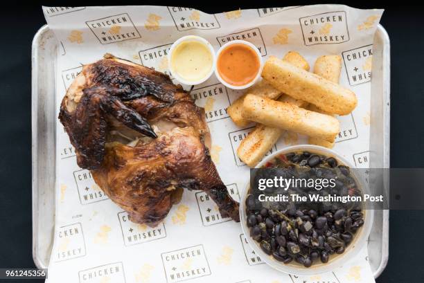 Pollo A La Brasa - South American rotisserie chicken with yuca fries & black beans at Chicken Whiskey in Washington, DC on March 8, 2018.