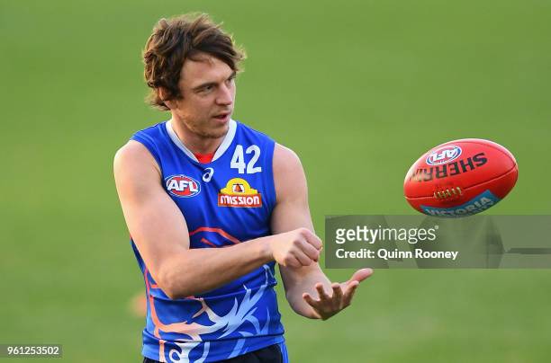 Liam Picken of the Bulldogs handballs during a Western Bulldogs AFL training session at Whitten Oval on May 22, 2018 in Melbourne, Australia.