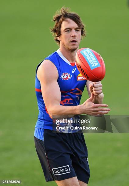 Liam Picken of the Bulldogs handballs during a Western Bulldogs AFL training session at Whitten Oval on May 22, 2018 in Melbourne, Australia.