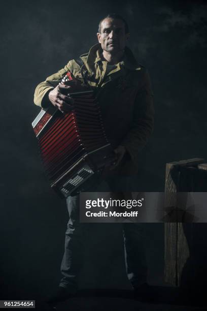 serious musican playing music of the great patriotic war on accordion - musican imagens e fotografias de stock