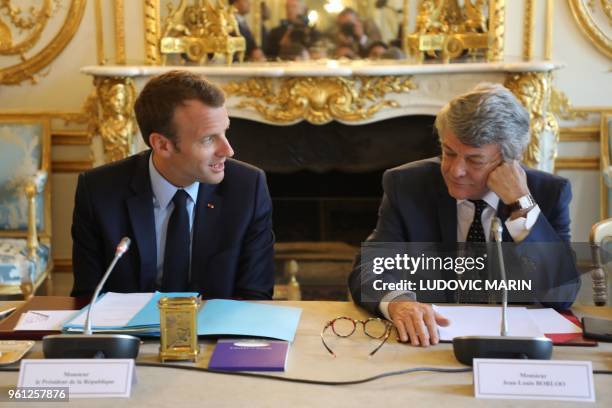French president Emmanuel Macron speaks with former Environment minister Jean-Louis Borloo, in charge of a mission on the priority neighbourhoods in...
