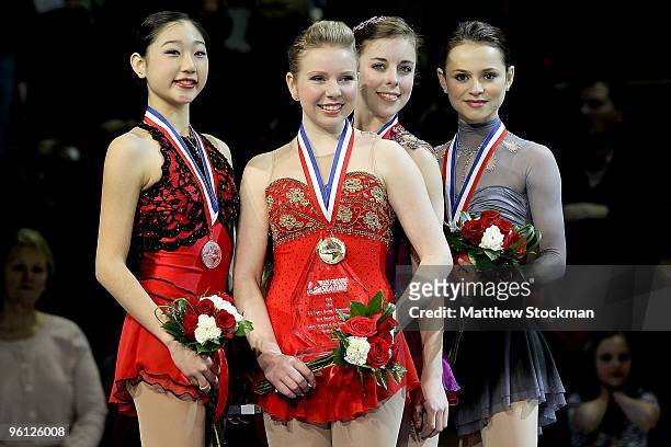 Mirai Nagasu, Rachael Flatt, Ashley Wagner and Sasha Cohen pose for photographers after the medal ceremony for the championship ladies event during...