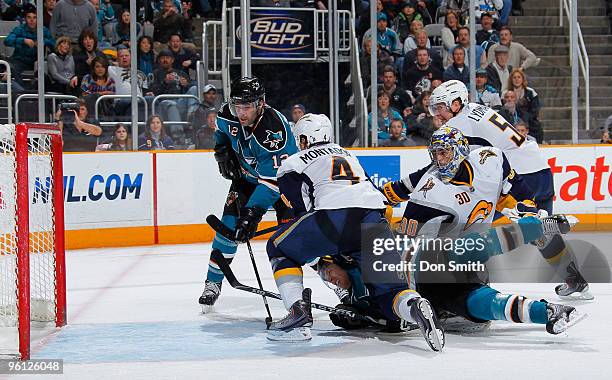 Steve Montador, Ryan Miller and Toni Lydman of the Buffalo Sabres watch as Joe Pavelski of the San Jose Sharks taps the puck in the net by teammate...