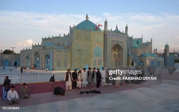 In this photograph taken on May 21 Afghan Muslim men offer their evening prayers during the Islamic holy month of Ramadan in the courtyard of the...