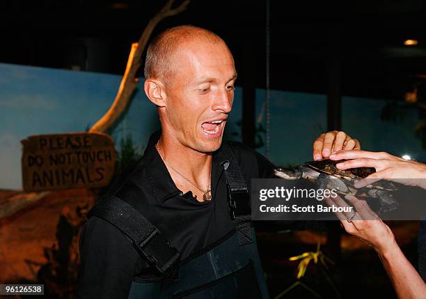 Nikolay Davydenko of Russia pats a turtle during a visit to Melbourne Aquarium on day seven of the 2010 Australian Open on January 24, 2010 in...