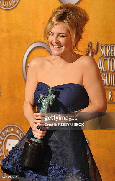 Drew Barrymore poses with her trophy for Outstanding Performance by a Female Actor in a Television Movie or Miniseries for "Grey Gardens" at the 16th...
