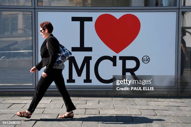 Pedestrian walks past a sign of support for Manchester set up in the wake of the Manchester Arena bombing in central Manchester on May 22 the one...