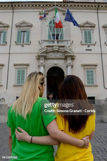 Tourists dressed in yellow and green to reflect the colours of the Five Stars Movement and the League party pose for photos in front of the Quirinale...