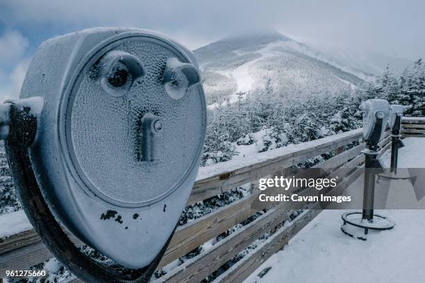 snow covered coin-operated binoculars against mountains at observation point - lake placid foto e immagini stock