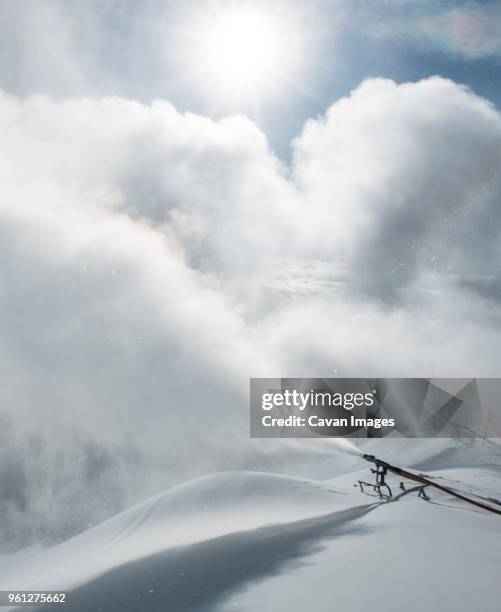 snowblowers blowing snow on field - schnee pusten stock-fotos und bilder