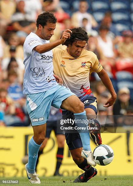 Alex Brosque of Sydney is challenged by Nikolai Topor-Stanley of the Jets during the round 24 A-League match between the Newcastle Jets and Sydney FC...