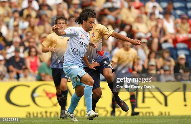 Alex Brosque of Sydney is challenged by Nikolai Topor-Stanley of the Jets during the round 24 A-League match between the Newcastle Jets and Sydney FC...