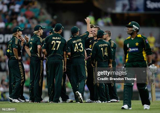 Peter Siddle of Australia celebrates with team mates after claiming the wicket of Umar Akmal of Pakistan during the second One Day International...