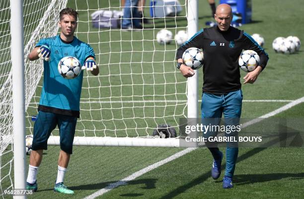 Real Madrid's French coach Zinedine Zidane and his son Real Madrid's French goalkeeper Luca Fernandez attend a training session during Real Madrid's...