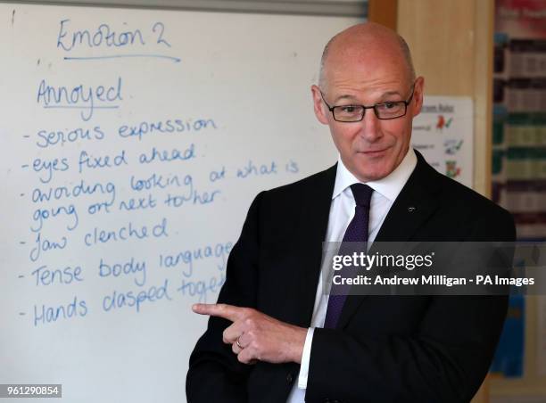 Education Secretary John Swinney stands in front of a white board as he listens into a class at Clydebank High School in Clydebank where he announced...