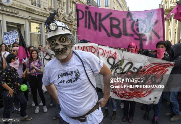 Protester wearing a costume mask and a shirt reading "Angry sewer worker" takes part in a demonstration on May 22 in Lyon, central-eastern France, as...