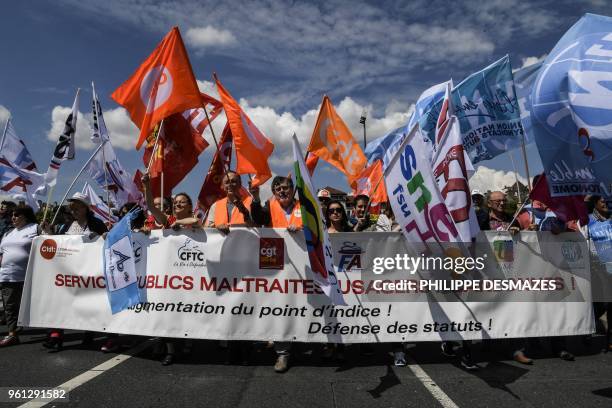 Protesters take part in a demonstration on May 22 in Lyon, central-eastern France, as part of a nationwide day of striking by French public sector...