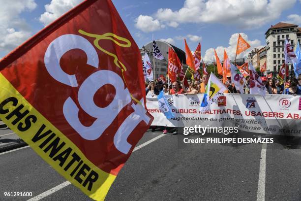 Protesters take part in a demonstration on May 22 in Lyon, central-eastern France, as part of a nationwide day of striking by French public sector...