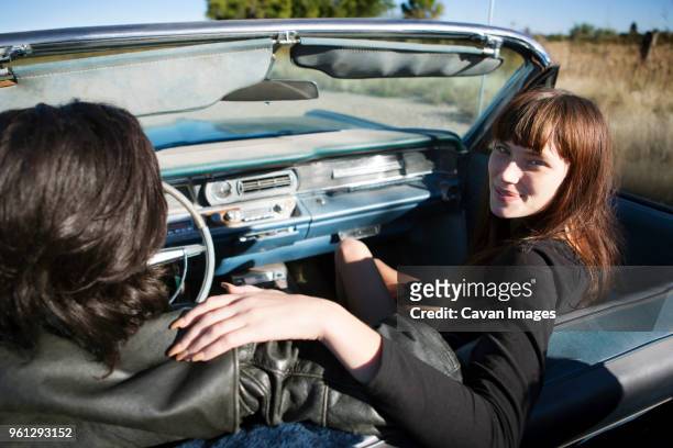 portrait of woman sitting with man in convertible - marfa texas stock pictures, royalty-free photos & images