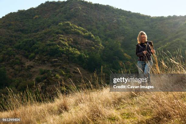 woman holding stick while standing on mountain - santa rosa california stock pictures, royalty-free photos & images