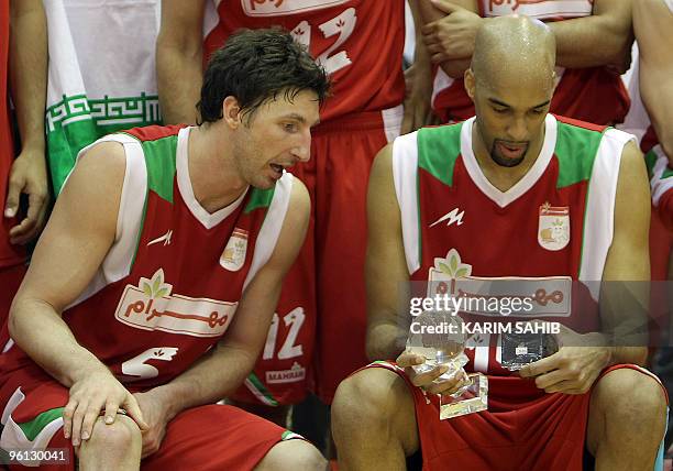 Player Jackson Vroman of Iran's Mahram club speaks with his teammate and countryman Loren Woods following their Dubai International Basketball...