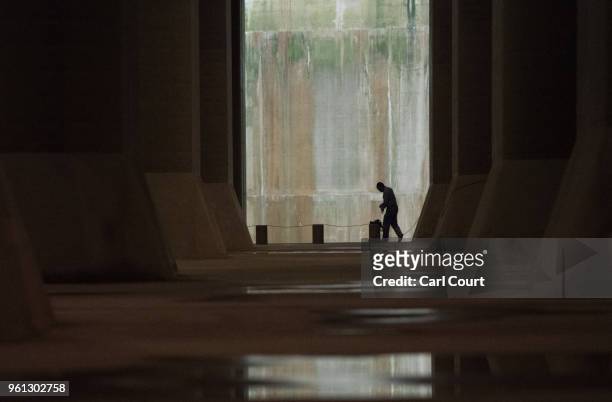 Member of staff walks through the pressure-adjusting water tank of the Tokyo Metropolitan Area Outer Underground Discharge Channel is pictured on May...
