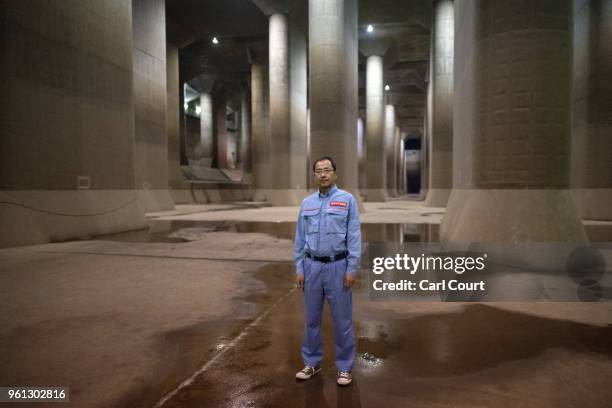 Yasuyuki Osa, a Section Manager, poses for a photograph in the pressure-adjusting water tank of the Tokyo Metropolitan Area Outer Underground...