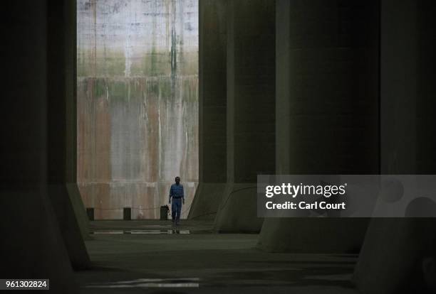 Member of staff walks through the pressure-adjusting water tank of the Tokyo Metropolitan Area Outer Underground Discharge Channel is pictured on May...