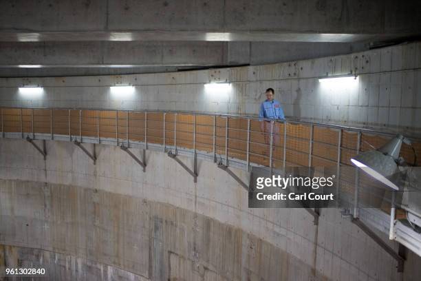 Yasuyuki Osa, a Section Manager, walks along a footway on the wall of a cistern linked to the pressure-adjusting water tank of the Tokyo Metropolitan...