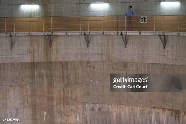 Yasuyuki Osa, a Section Manager, poses for a photograph on a footway on the wall of a cistern linked to the pressure-adjusting water tank of the...