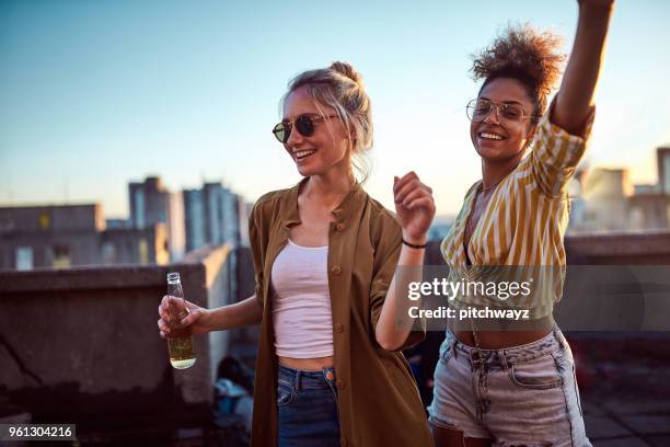 two women dancing at the party. - summer party imagens e fotografias de stock