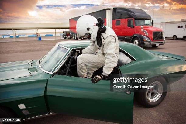 sportsman sitting in vintage car while preparing for sports race - vintage car racing stock pictures, royalty-free photos & images