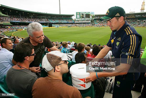 Peter Siddle of Australia collects money from cricket fans for the victims of the recent Haiti earthquake during the second One Day International...