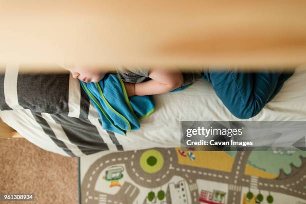 high angle view of boy sleeping on bunkbed - bunk beds for 3 stock-fotos und bilder