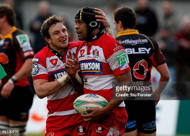 Gloucester forward Akapusi Qera is congratulated by Rory Lawson after scoring the first Gloucester try during the Heineken Cup Pool 2, Round 6 match...
