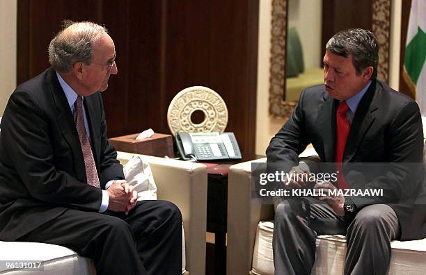 Jordan's King Abdullah II speaks with US Middle East envoy George Mitchell during a meeting at the Royal Palace in Amman on January 24, 2010....