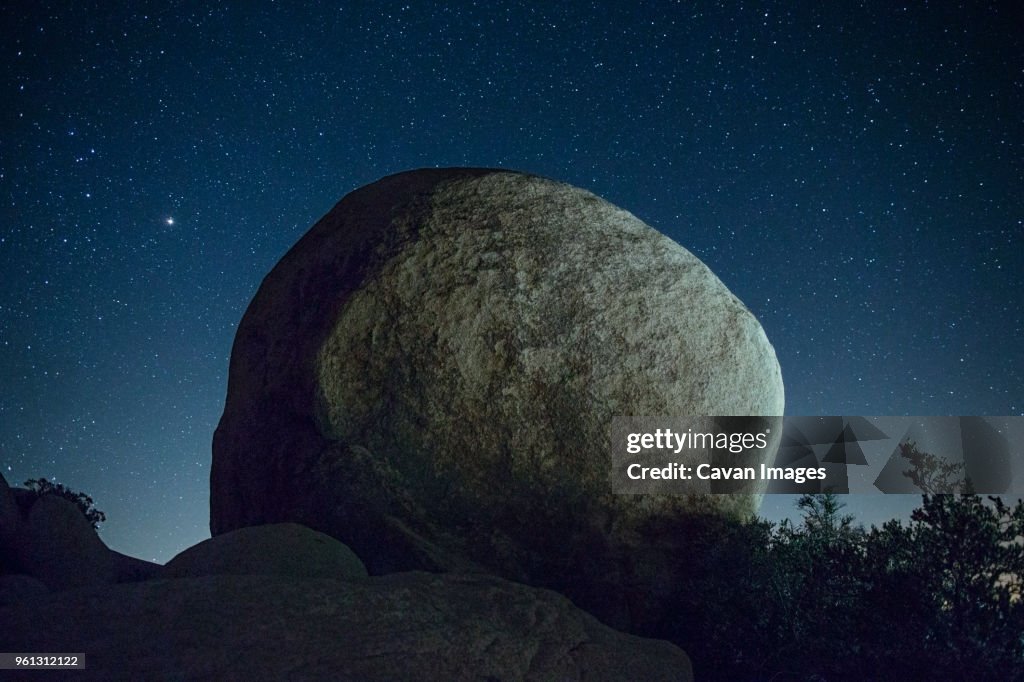 Rock against star field at night