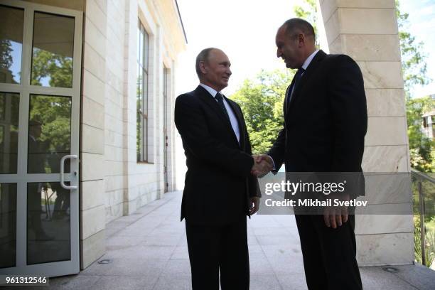 Russian President Vladimir Putin greets Bulgarian President Rumen Radev during their meeting at Bocharov Ruchey Presidential Summer Residence on May...