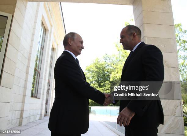 Russian President Vladimir Putin greets Bulgarian President Rumen Radev during their meeting at Bocharov Ruchey Presidential Summer Residence on May...