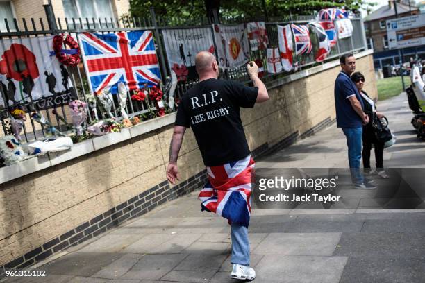 Man wearing a commemorative t-shirtsfilms on a mobile phone at site of the murder of Fusilier Lee Rigby on the fifth anniversary of his death on May...