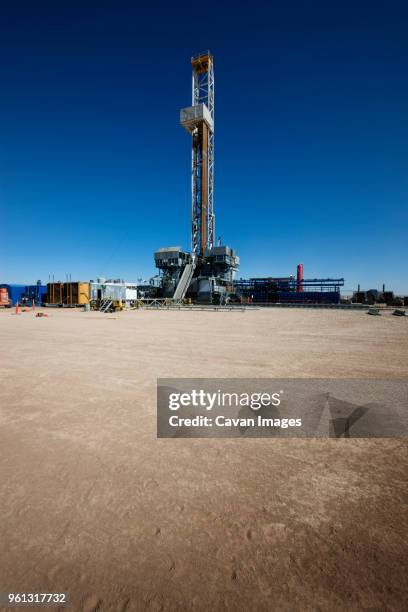 power plant on field against clear blue sky - sky plant stock pictures, royalty-free photos & images