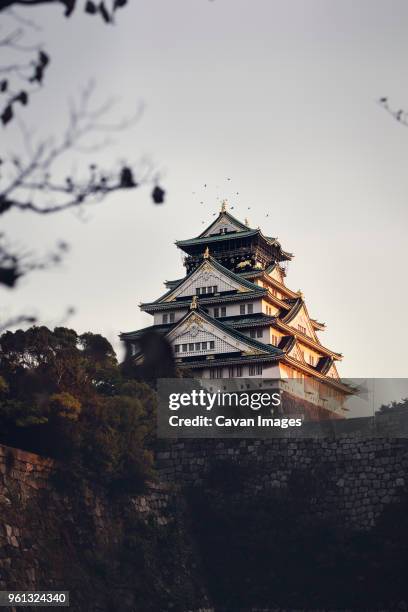 low angle view of osaka castle against clear sky during sunset - osaka stock pictures, royalty-free photos & images